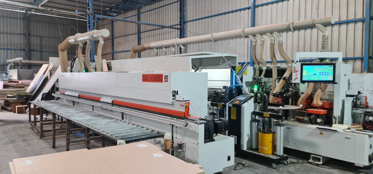 An edge-banding line in the OutDo factory near Pune, finishing panels for an order